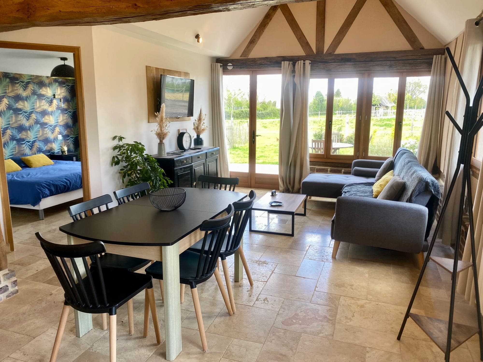 Living space at Gîte Cerise: dining and sitting areas under exposed beams