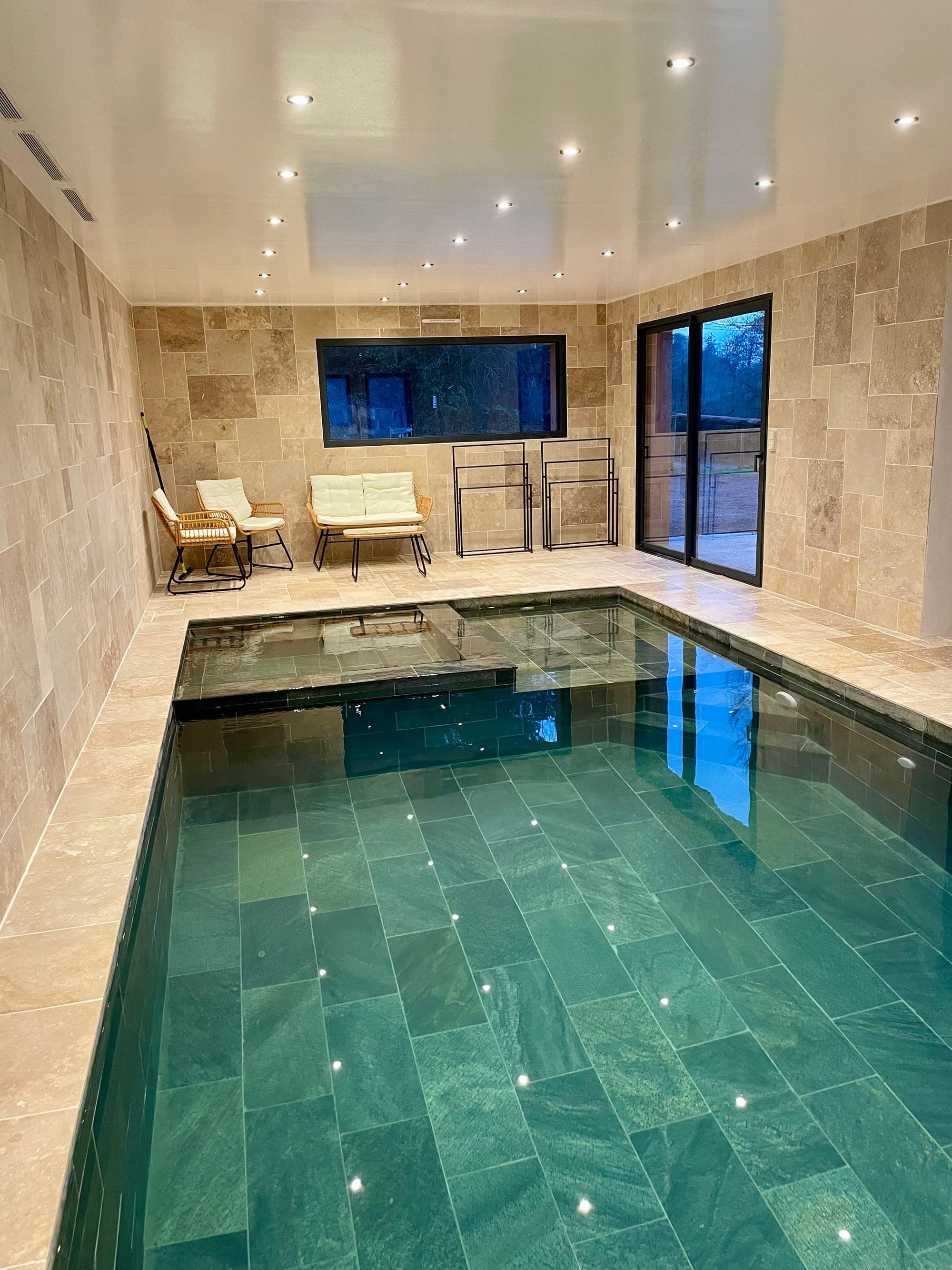 Indoor pool at Gîte Myrtille, bathed in light from its large windows