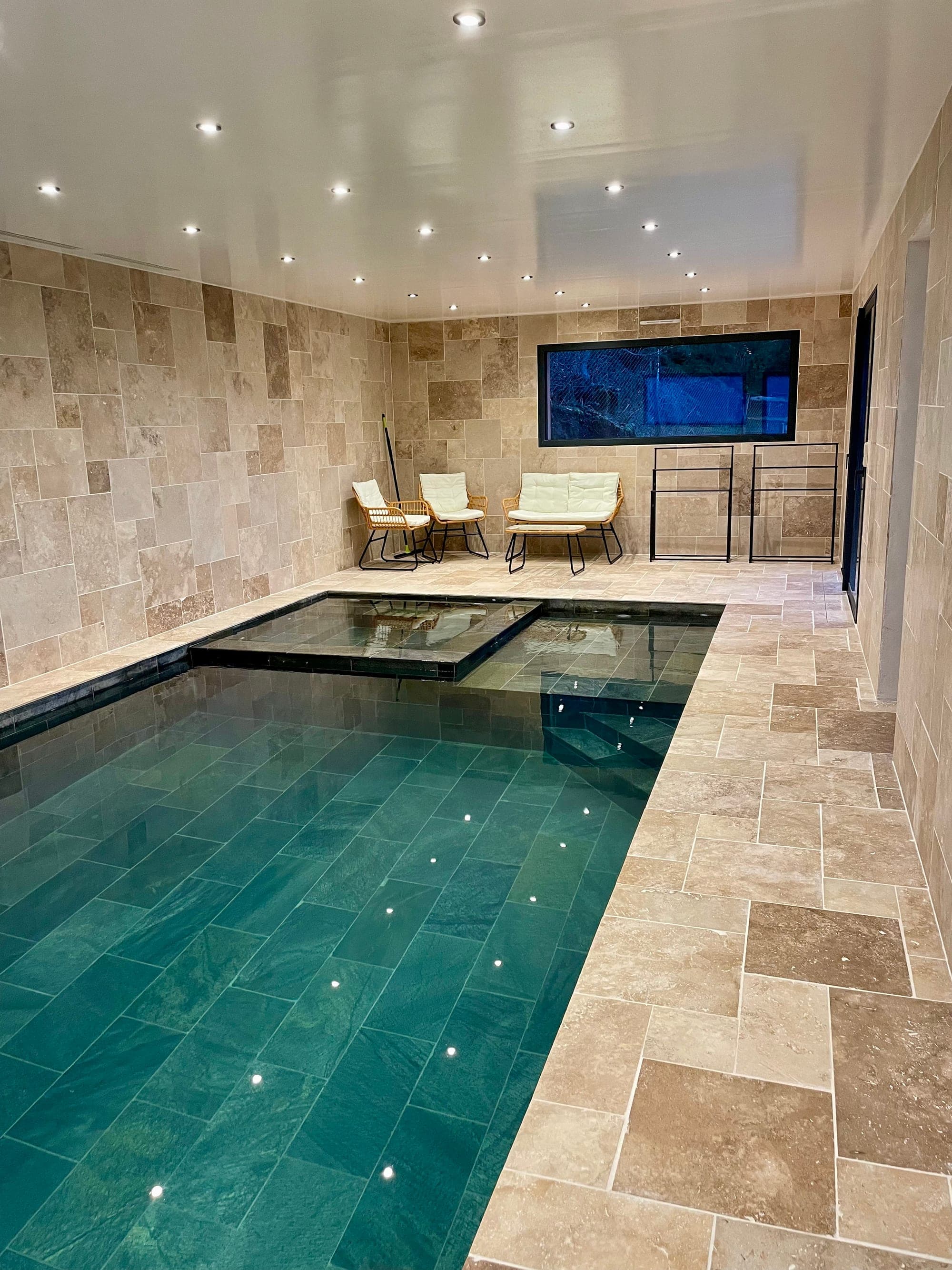 Private heated indoor pool at Gîte Myrtille, with jacuzzi and lounge area, open all year round