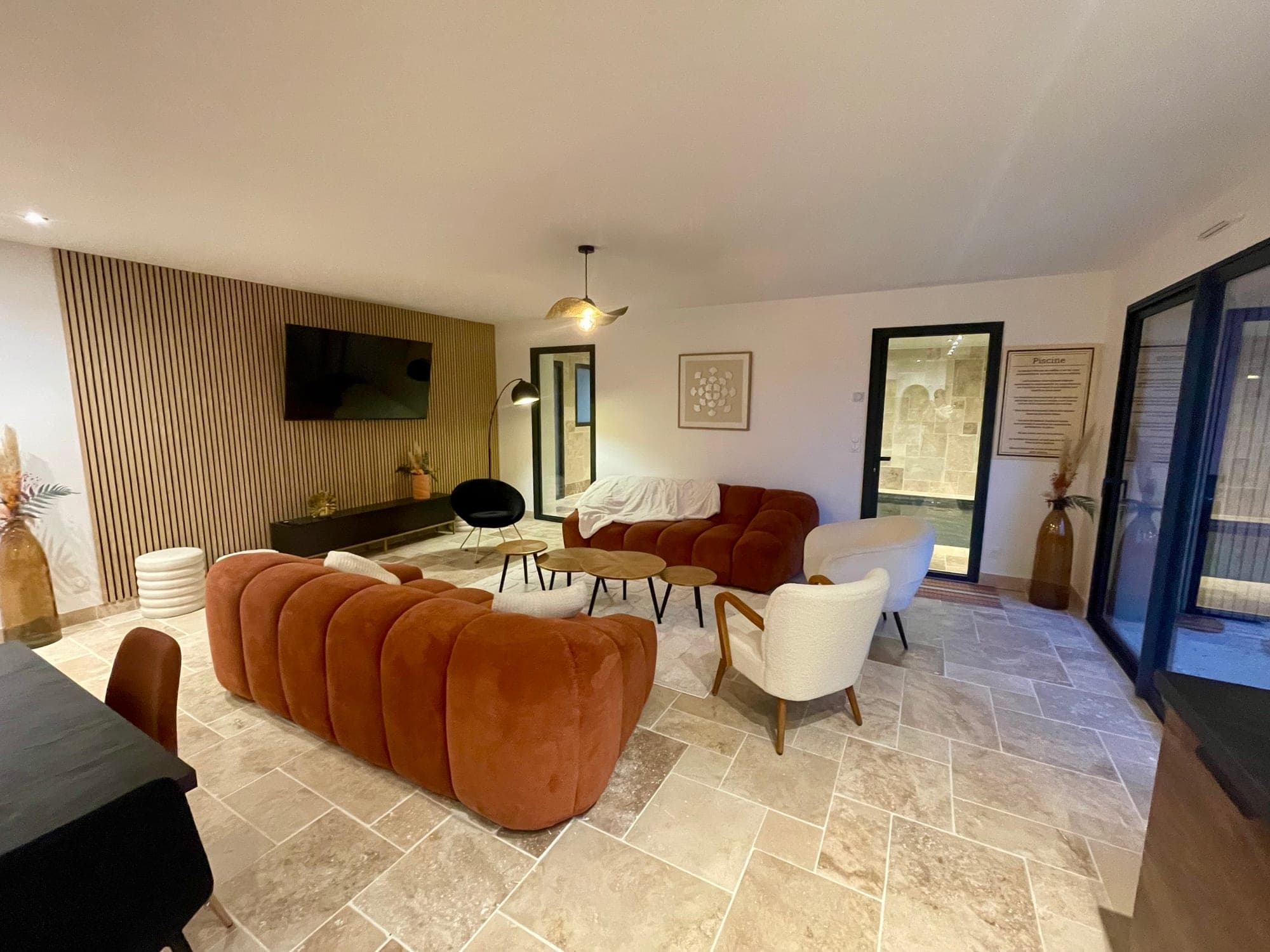 TV lounge next to the indoor pool at Gîte Myrtille