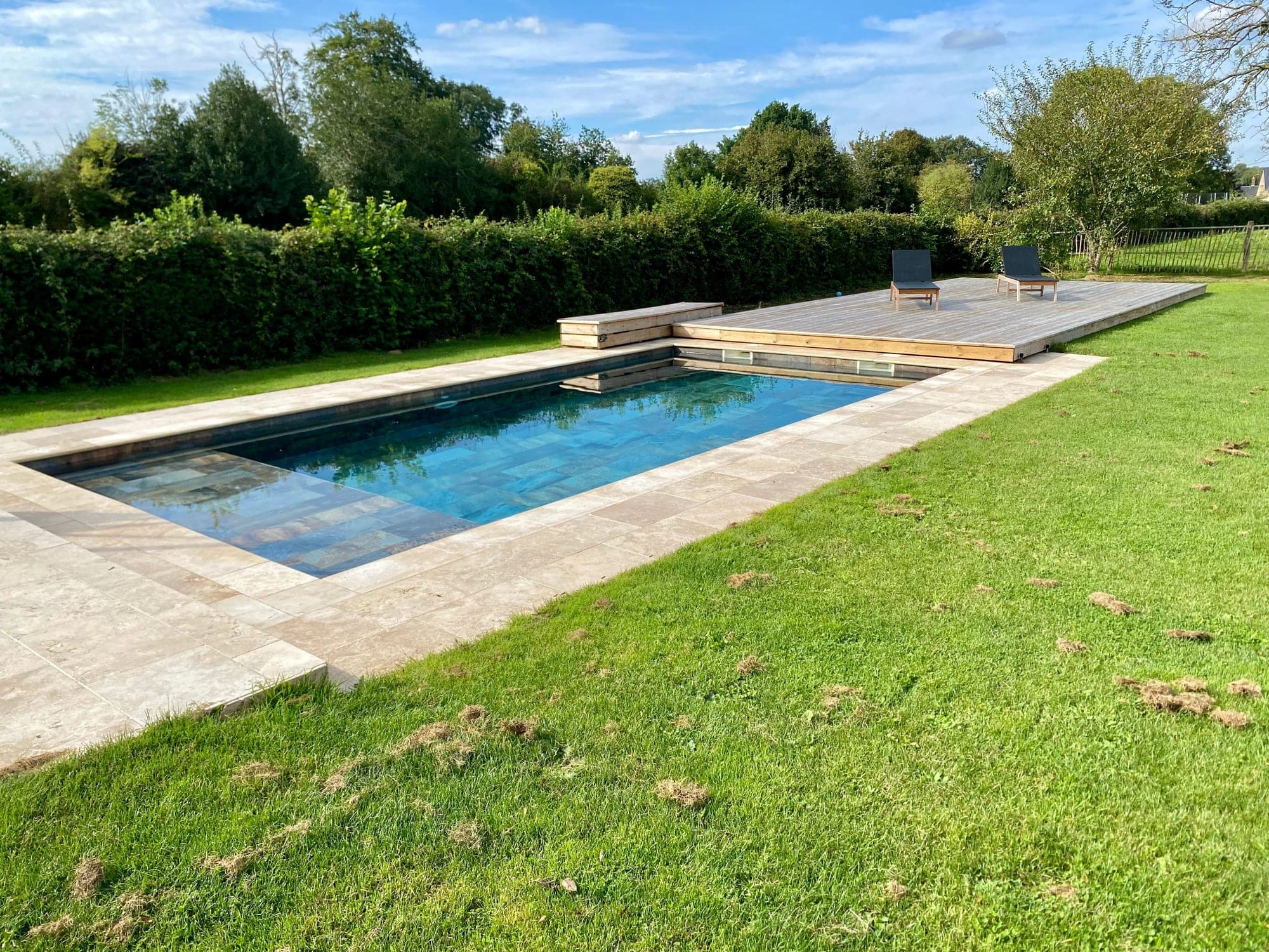 Heated pool shared by the Cerise and Mirabelle houses, with a wooden deck and sun loungers