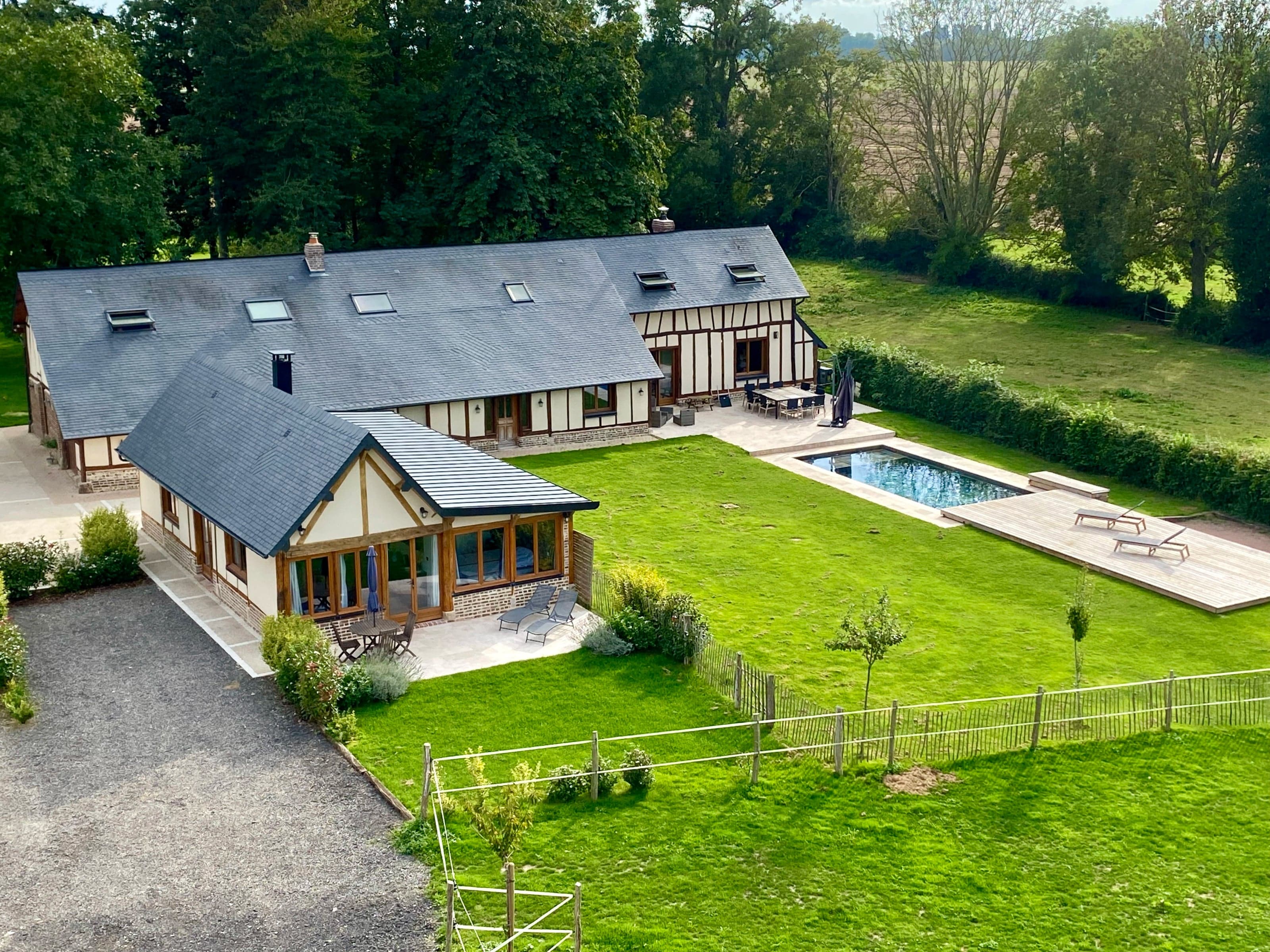 Aerial view of the Gîtes de l'Epinay estate in Saint-Saëns, Normandy, with its pool and half-timbered houses